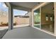 Covered patio featuring a smooth concrete floor, sliding glass doors, and views of the backyard at 1571 Montgomery Bell Rd, Wesley Chapel, FL 33543