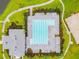 Aerial view of a rectangular swimming pool with lap lanes, complemented by nearby lounge areas and landscaping at 1571 Montgomery Bell Rd, Wesley Chapel, FL 33543