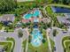 Aerial view of two resort-style pools with ample lounging space, surrounded by trees, and landscaping at 1571 Montgomery Bell Rd, Wesley Chapel, FL 33543