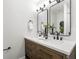 Bathroom with double sink vanity, dark hardware, and tiled shower at 1600 Connecticut Ne Ave, St Petersburg, FL 33703