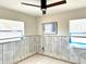 Bright bedroom with a ceiling fan, ready for renovation with exposed concrete walls and natural light at 1600 Connecticut Ne Ave, St Petersburg, FL 33703