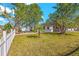 Charming home with well-maintained lawn, small palm tree, and white picket fence at 1600 Connecticut Ne Ave, St Petersburg, FL 33703
