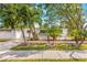 Charming single-story home featuring lush palm trees, a well-manicured lawn, and a welcoming front entrance at 1600 Connecticut Ne Ave, St Petersburg, FL 33703
