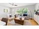 Bright living room with a ceiling fan, a cozy couch, a stylish coffee table, and hardwood floors at 1600 Connecticut Ne Ave, St Petersburg, FL 33703