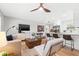 Open living space features a ceiling fan, a comfy sofa, a TV, and modern furnishings at 1600 Connecticut Ne Ave, St Petersburg, FL 33703