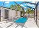 Screened pool with waterfall feature, door to backyard, and sleek, modern design at 1600 Connecticut Ne Ave, St Petersburg, FL 33703