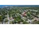 An aerial view shows the property's location within a lush, green neighborhood near Tampa Bay at 1623 San Mateo Dr, Dunedin, FL 34698