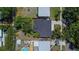 Birds eye view of the home in its lot showing the roof and landscaping at 1623 San Mateo Dr, Dunedin, FL 34698