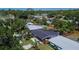 An aerial view of a quaint neighborhood featuring lush greenery and serene homes with swimming pools in their backyard at 1623 San Mateo Dr, Dunedin, FL 34698