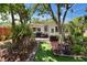 Serene back yard featuring lush landscaping, an outdoor seating area and privacy at 1623 San Mateo Dr, Dunedin, FL 34698