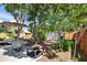 A beautiful backyard with a table, chairs, umbrella, and a shed surrounded by lush greenery at 1623 San Mateo Dr, Dunedin, FL 34698