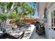 A spacious outdoor patio with furniture, a grill, and a fenced yard perfect for entertaining at 1623 San Mateo Dr, Dunedin, FL 34698