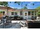 An inviting backyard offers a patio with comfortable seating, grill, and lush greenery at 1623 San Mateo Dr, Dunedin, FL 34698