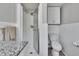 Bright bathroom with tiled walk-in shower, white cabinets, toilet, and chrome fixtures at 1623 San Mateo Dr, Dunedin, FL 34698