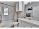 Clean, bright bathroom with tub-shower combo, marble-look shower tiles, and modern vanity at 1623 San Mateo Dr, Dunedin, FL 34698