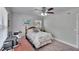 Cozy bedroom featuring a ceiling fan, plush carpet, and a comfortable single bed at 1623 San Mateo Dr, Dunedin, FL 34698