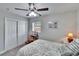 Bedroom with closet, ceiling fan, patterned bedspread, and bright window providing ample light at 1623 San Mateo Dr, Dunedin, FL 34698