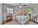 Comfortable bedroom featuring a ceiling fan and a view to the backyard at 1623 San Mateo Dr, Dunedin, FL 34698