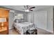Comfortable bedroom featuring ceiling fan, plush patterned bedspread, closet, and bright window at 1623 San Mateo Dr, Dunedin, FL 34698