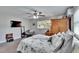 Cozy bedroom with plush bed, ceiling fan, armoire, and bright window for natural light at 1623 San Mateo Dr, Dunedin, FL 34698