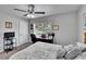 Bedroom featuring a bed, ceiling fan, window, door, and desk with computer at 1623 San Mateo Dr, Dunedin, FL 34698