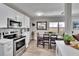 Open-concept kitchen and dining area, bright with white cabinets and stainless steel appliances at 1623 San Mateo Dr, Dunedin, FL 34698