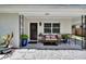 Welcoming front door with decorative wreath, stylish exterior lighting, and comfortable porch seating at 1623 San Mateo Dr, Dunedin, FL 34698