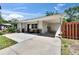 Charming home with a covered carport, well-manicured landscaping, and inviting curb appeal at 1623 San Mateo Dr, Dunedin, FL 34698