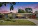 Charming single-story home with a well-maintained lawn, inviting curb appeal, and attached carport at 1623 San Mateo Dr, Dunedin, FL 34698