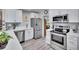 Modern kitchen with stainless steel appliances, white cabinets, and quartz countertops at 1623 San Mateo Dr, Dunedin, FL 34698