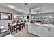 Open-concept living area featuring dining space, a cozy couch, and plenty of natural light from large windows at 1623 San Mateo Dr, Dunedin, FL 34698