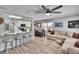 Open-concept living space featuring a modern kitchen, dining area, and comfortable seating area at 1623 San Mateo Dr, Dunedin, FL 34698