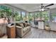 Bright and airy sunroom with lots of windows and comfortable seating at 1623 San Mateo Dr, Dunedin, FL 34698