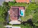 Luxury home with a beautiful pool, patio, and manicured grounds seen from an aerial perspective at 17003 Madres De Avila, Tampa, FL 33613