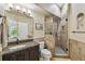 Elegant bathroom featuring a granite countertop, a walk-in shower, and tile flooring at 17003 Madres De Avila, Tampa, FL 33613