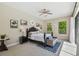 Bedroom with a dark wood bed frame, ceiling fan, and an outdoor view at 17003 Madres De Avila, Tampa, FL 33613