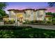 Elegant home with a red tile roof, cream-colored stucco, manicured lawn, and columns at the entryway at 17003 Madres De Avila, Tampa, FL 33613
