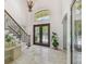 Elegant foyer features high ceilings, marble floors, staircase, and double doors with decorative glass at 17003 Madres De Avila, Tampa, FL 33613