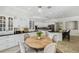 Open concept kitchen with granite counters, white cabinetry, and an adjacent breakfast nook at 17003 Madres De Avila, Tampa, FL 33613
