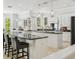 Large kitchen with dual islands, granite counters, white cabinetry, and breakfast bar at 17003 Madres De Avila, Tampa, FL 33613