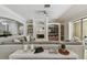 Cozy living room with a fireplace, built-in shelving, and a large sectional sofa at 17003 Madres De Avila, Tampa, FL 33613