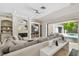 Bright living room with a fireplace, built-in shelving, and access to the outdoor area at 17003 Madres De Avila, Tampa, FL 33613