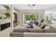 Living area featuring a fireplace, a large sectional, and a view of the pool area at 17003 Madres De Avila, Tampa, FL 33613