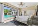 Comfortable bedroom with a large window and access to the outdoor pool area at 17003 Madres De Avila, Tampa, FL 33613