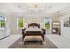 Expansive main bedroom suite boasts elegant decor, tray ceilings, a decorative chandelier, and a large mirror at 17003 Madres De Avila, Tampa, FL 33613