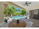 Covered patio with an outdoor dining area, overlooking a pool and well-maintained landscaping at 17003 Madres De Avila, Tampa, FL 33613