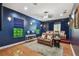 Home theater with leather reclining seats, a large screen, and hardwood floors for immersive entertainment experiences at 17003 Madres De Avila, Tampa, FL 33613