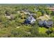 An aerial view shows the neighborhood and the house in a park-like setting at 1720 Mariner Way, Tarpon Springs, FL 34689