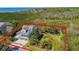 Stunning coastal home with lush landscaping and panoramic views, outlined in red at 1720 Mariner Way, Tarpon Springs, FL 34689