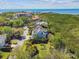 Scenic aerial view of a coastal home surrounded by lush greenery, ocean, and waterfront buildings at 1720 Mariner Way, Tarpon Springs, FL 34689